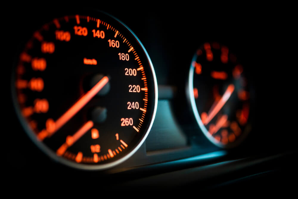 Close up of a speedometer on a car dashboard