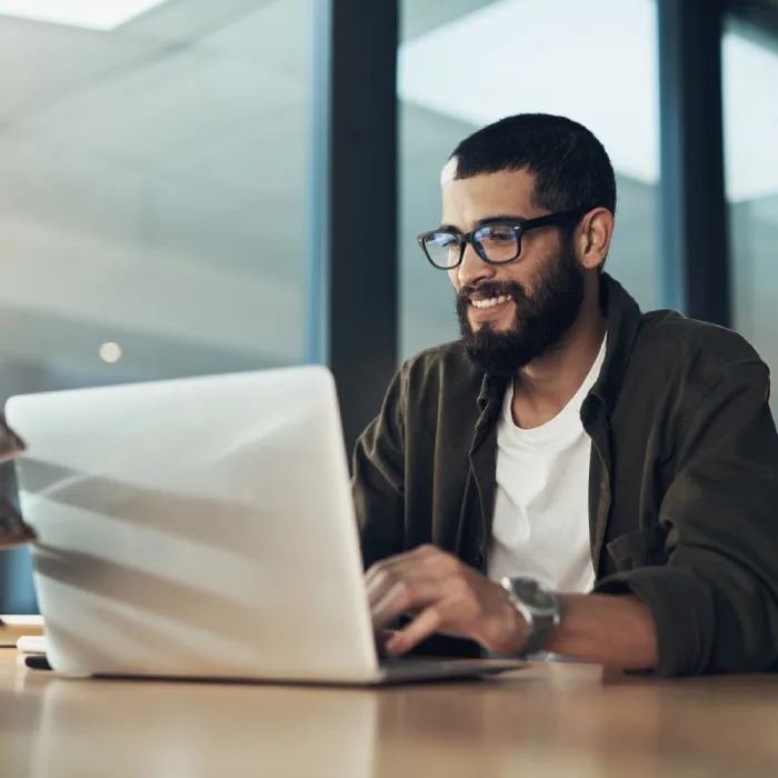 man with a laptop working at a table