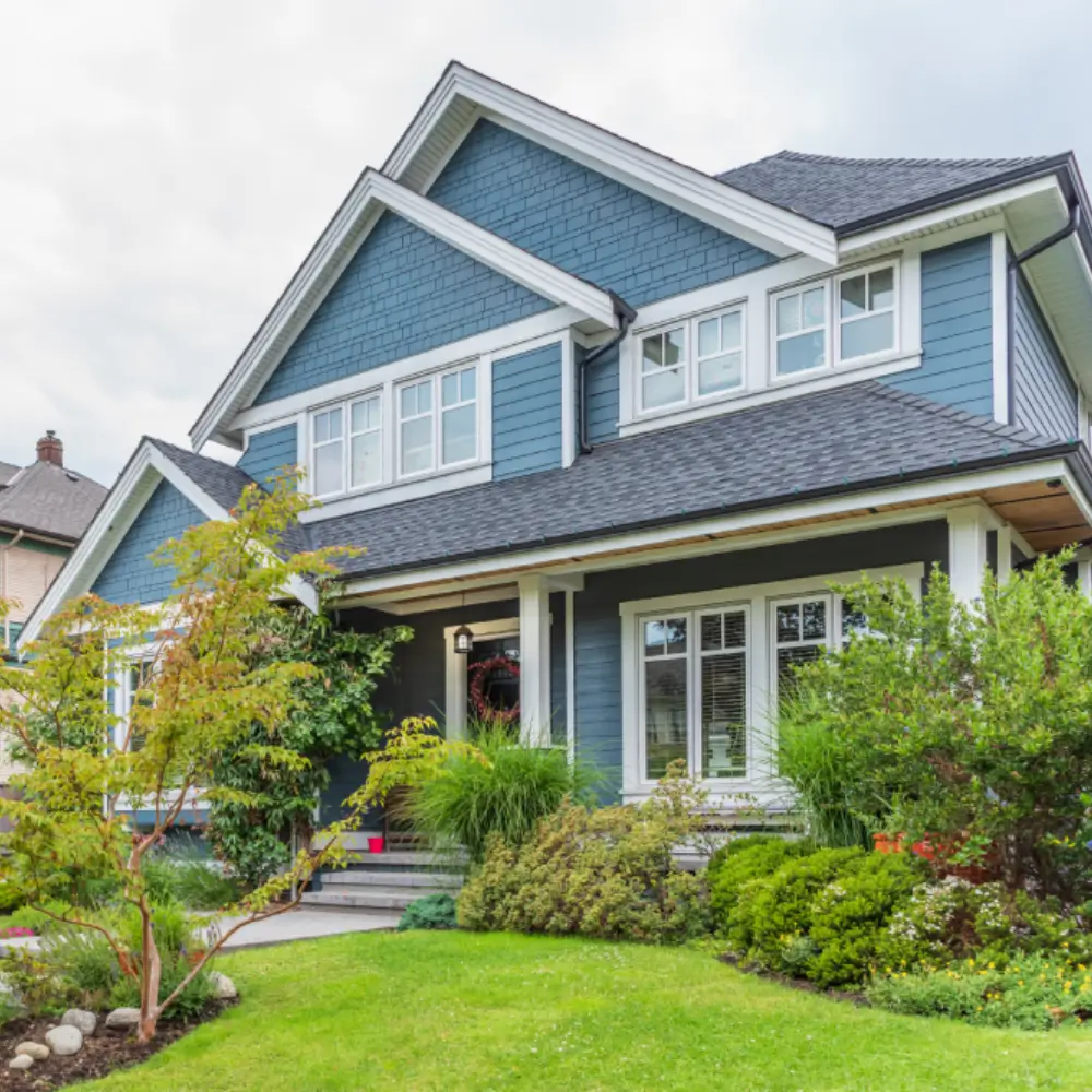 a large blue house in a neighborhood